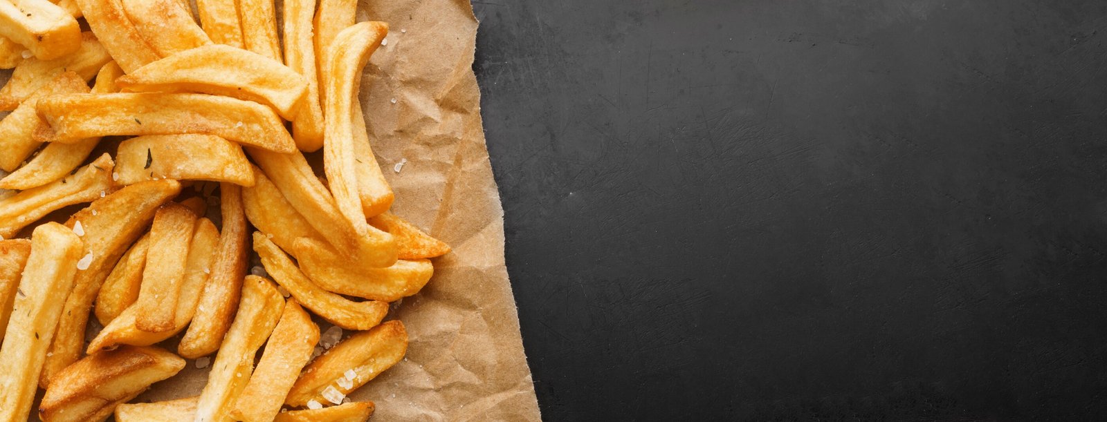 top-view-of-french-fries-on-paper-with-copy-space.jpg